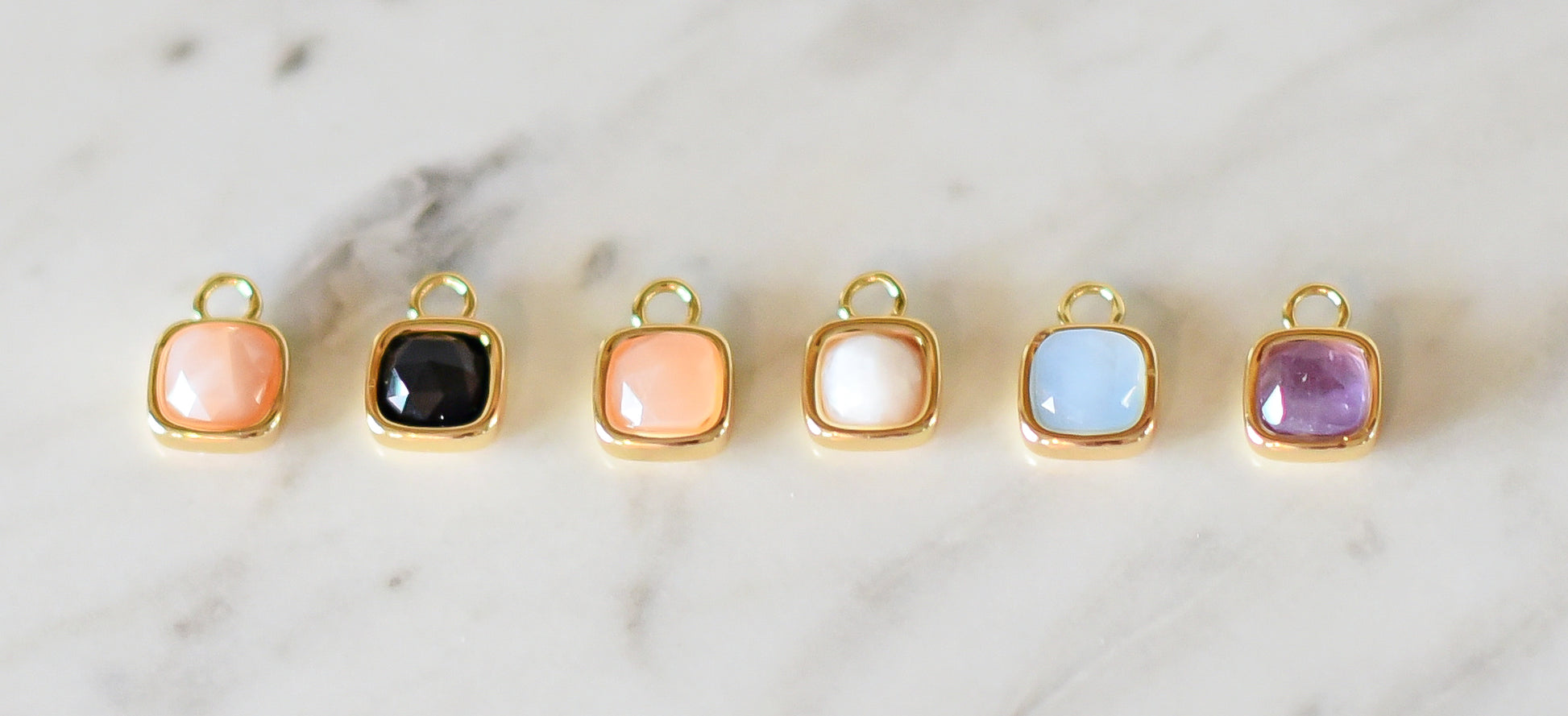 Left to Right: Pink Quartz, Black Onyx, Sandstone, Moonstone, Blue Quartz, Amethyst